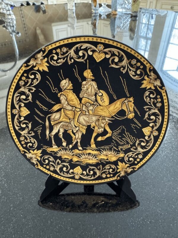 A Gold Etched Carbon Plate with an image of a man riding a horse.